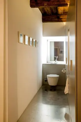 a bathroom with a white toilet and a window at FishSquare in Ljubljana