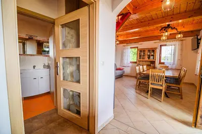 a kitchen and dining room with a table and chairs at Holiday Home Sunny at vineyard in Veliki Kamen