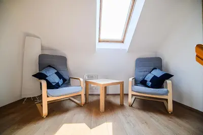 two chairs and a table in a room at Holiday Home Sunny at vineyard in Veliki Kamen