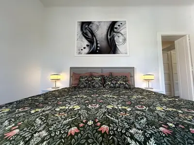 a bedroom with a bed with a floral bedspread at Luxury Apartment Privoz in Ljubljana