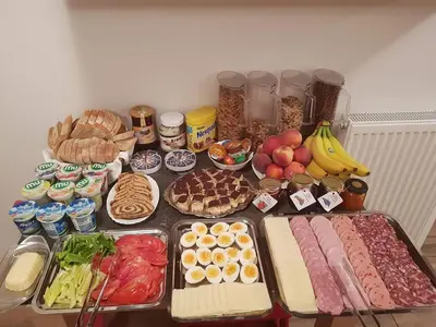 a table with many different types of food on it at Tourist farm Megušar in Škofja Loka