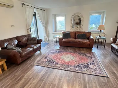 a living room with two couches and a rug at Hisa Pelance in Tolmin