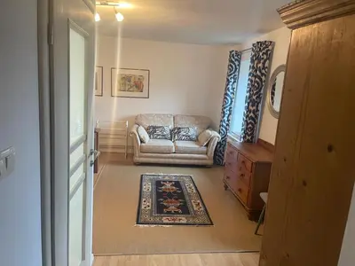 a living room with a couch and a rug at Hisa Pelance in Tolmin
