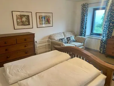 a bedroom with a bed and a chair and a dresser at Hisa Pelance in Tolmin