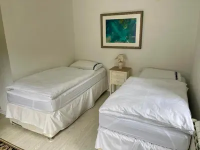 two twin beds in a room with a picture on the wall at Hisa Pelance in Tolmin