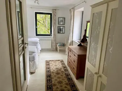 a room with a bedroom with a dresser and a window at Hisa Pelance in Tolmin