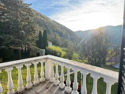 a white balcony with a view of a mountain at Hisa Pelance in Tolmin
