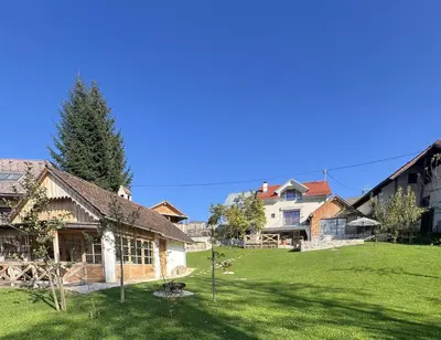 a large yard with a house and a building at PAVI APARTMENTS River Estate Krka in Krka