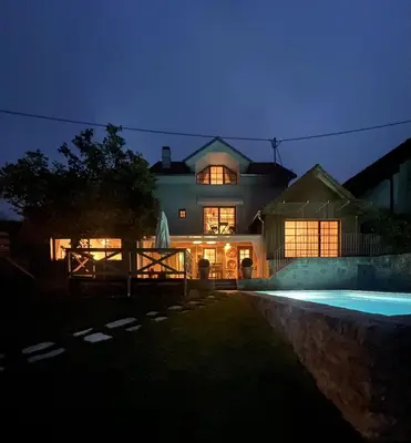 a large house with a swimming pool at night at PAVI APARTMENTS River Estate Krka in Krka