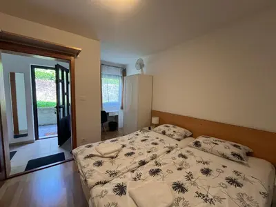 a bedroom with a bed and a large window at Apartments and Rooms Tajcr in Bovec