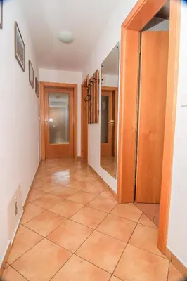 a hallway with a door and a tile floor at Apartments and Rooms Tajcr in Bovec