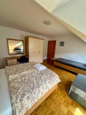 a bedroom with a bed and a couch at Apartments and Rooms Tajcr in Bovec