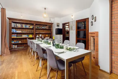 a long dining room with a long table and chairs at Cozy house close to Ljubljana center in Ljubljana