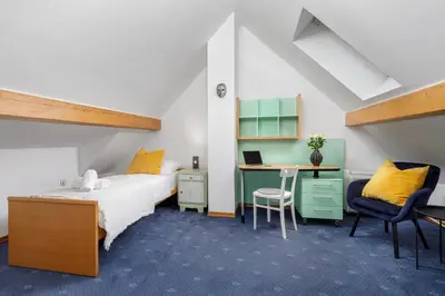 a bedroom with a bed and a desk with a computer at Cozy house close to Ljubljana center in Ljubljana