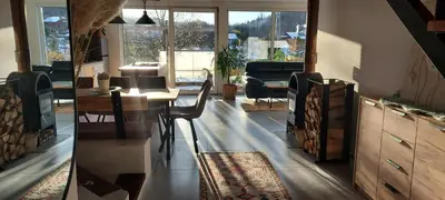 a living room with a table and chairs and a desk at Hiša Galeria in Loče pri Poljčanah