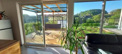 a living room with a sliding glass door with a patio at Hiša Galeria in Loče pri Poljčanah