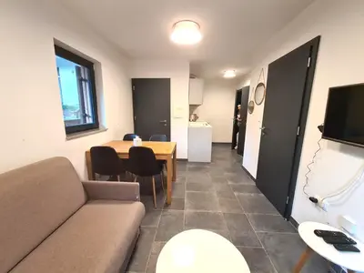 a living room with a couch and a table at Alpine Escape Golte Apartment in Mozirje