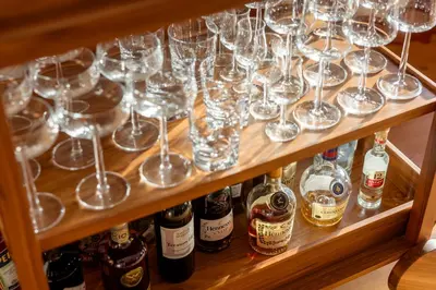 a bunch of wine glasses and bottles on a shelf at Chalet Jasna in Kranjska Gora
