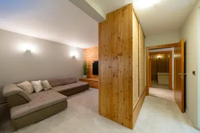 a living room with a couch and a wooden wall at Chalet Jasna in Kranjska Gora