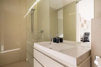 a white bathroom with a sink and a shower at Chalet Jasna in Kranjska Gora