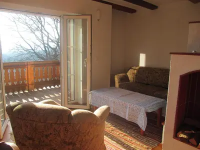 a living room with a couch and a chair at Holiday Home Sonnenhaus in Svečina