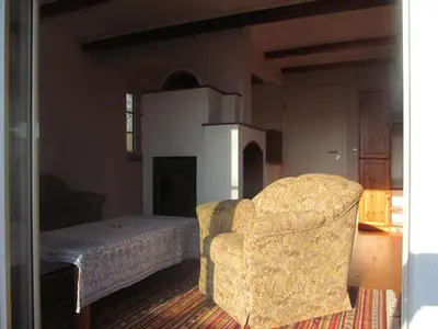 a living room with a chair and a bed at Holiday Home Sonnenhaus in Svečina