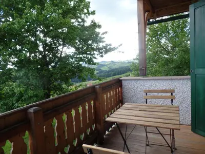 a wooden bench on a deck with a view at Holiday Home Sonnenhaus in Svečina