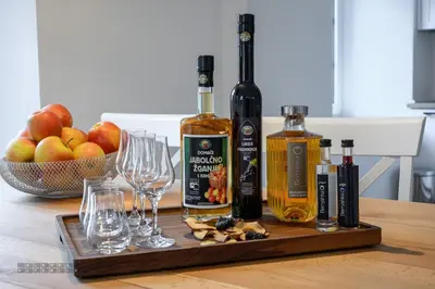 a wooden tray with wine bottles and glasses on a table at Hiša Janko in Dolenjske Toplice