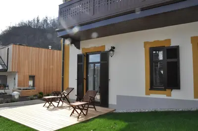 a house with a deck with chairs on it at Vila Mila in Bled