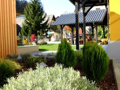 a garden in front of a building with a gazebo at Vila Mila in Bled