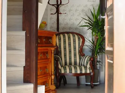 a chair sitting next to a wooden dresser at Vila Mila in Bled