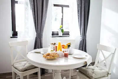 a white table with fruit on it in a room at Vila Mila in Bled