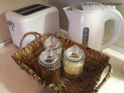 a basket with jars and a toaster on a counter at Apartment Villa Carolina in Kranjska Gora