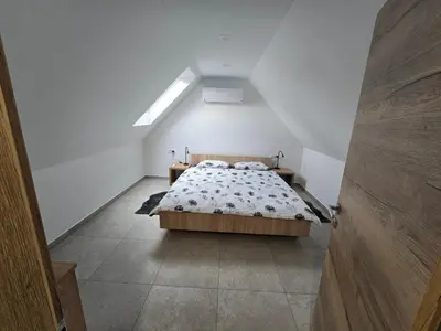 a bedroom with a bed in a attic at Apartma Termal Čatež - nastanitev z vključenimi 6-imi kopalnimi kartami - 6 tickets included in Čatež ob Savi