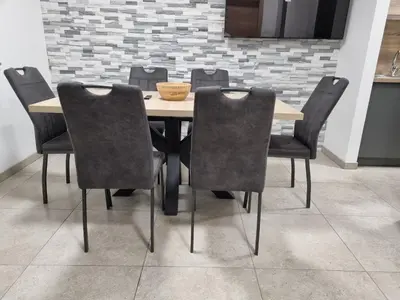 a dining room table with chairs and a bowl on it at Apartma Termal Čatež - nastanitev z vključenimi 6-imi kopalnimi kartami - 6 tickets included in Čatež ob Savi