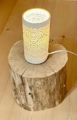 a bucket sitting on top of a wooden stump at Sweet Bee Cottage in Bovec