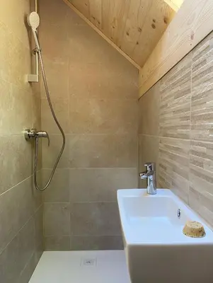 a bathroom with a shower and a sink at Sweet Bee Cottage in Bovec