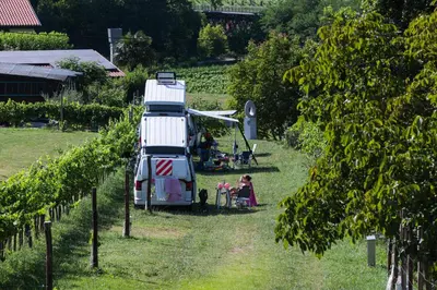 a food truck parked in a vineyard with people sitting inside at Saxida Wine & Camping Resort Pitches in Dornberk