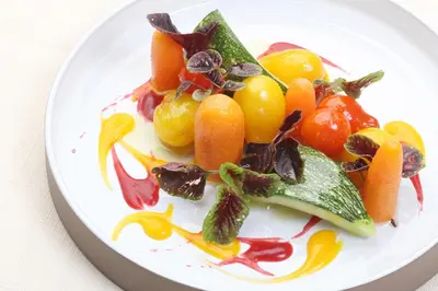 a plate of fruit and vegetables on a table at Saxida Wine & Camping Resort Pitches in Dornberk