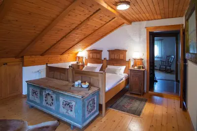 a bedroom with a large bed and a wooden ceiling at Chalet Zala in Kranjska Gora