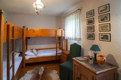 a bedroom with two bunk beds and a desk at Chalet Zala in Kranjska Gora