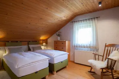 a bedroom with two beds and a wooden ceiling at Chalet Zala in Kranjska Gora