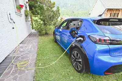 a blue car is hooked up to a house at Chalet Zala in Kranjska Gora