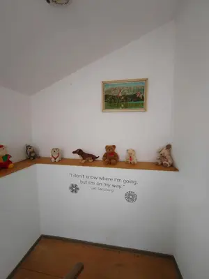a wall with a shelf with stuffed animals on it at Apartma SOFIA in Tolmin