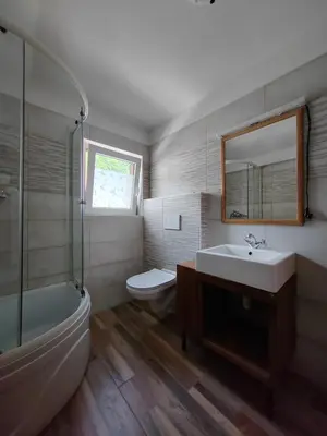 a bathroom with a tub and a sink and a toilet at Apartma SOFIA in Tolmin