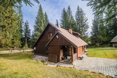 a small wooden house in the middle of a field at Cottage of Rising Sun in Goreljek