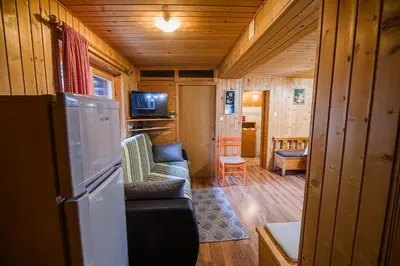 a living room with a couch and a refrigerator at Cottage of Rising Sun in Goreljek