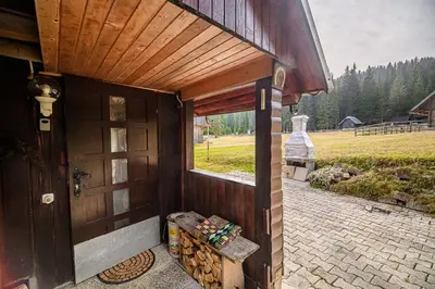 a wooden building with a door and a window at Cottage of Rising Sun in Goreljek