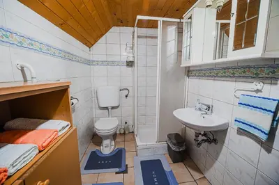 a small bathroom with a sink and a toilet at Cottage of Rising Sun in Goreljek