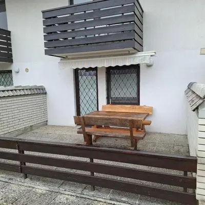 a bench sitting on the side of a building at Bohinj Planika J2 in Bohinj